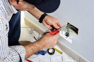 Electrician fixing outlet